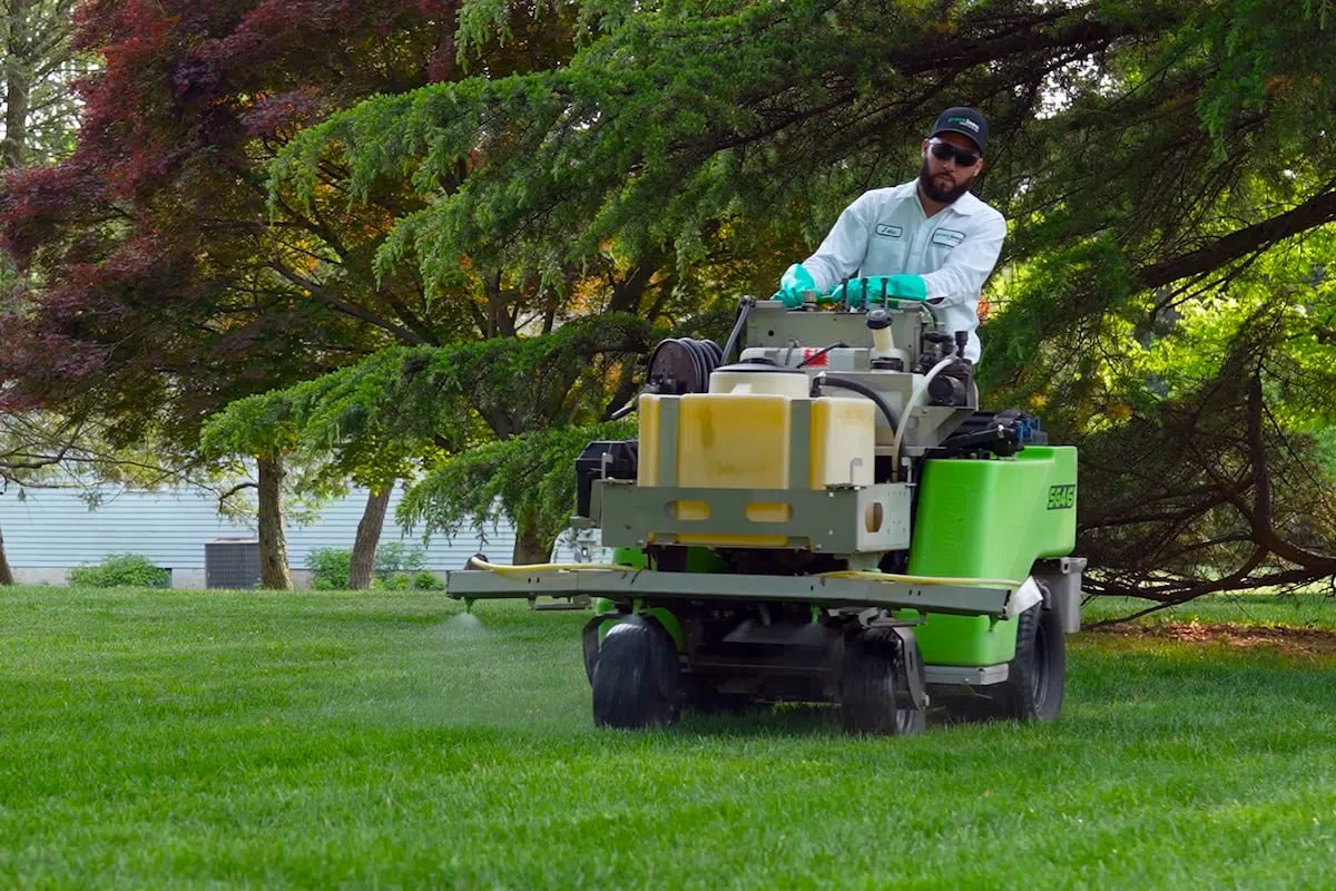 lawn care technician using liquid fertilizer