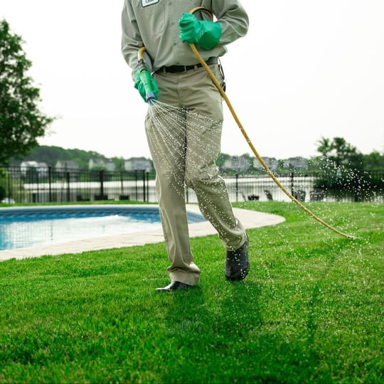 green lawn being fertilized by a certified technician