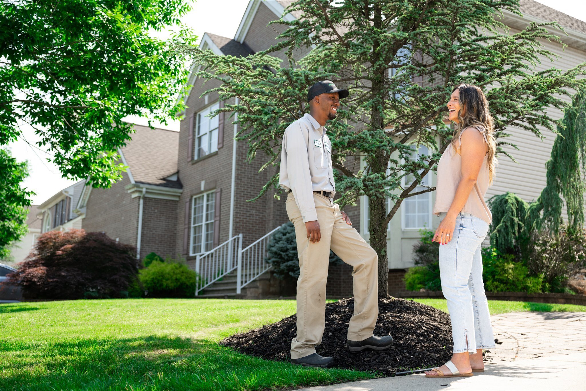 tech speaking with a customer about winter protection for trees and shrubs