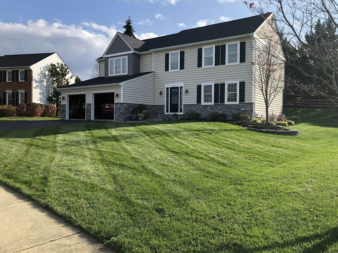 house with a lawn cared for by green lawn fertilizing
